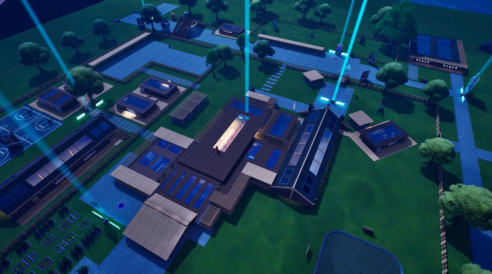 Aerial view of the Fortnite Virtual Marae complex with wharenui, māra kai, basketball court and beams of light